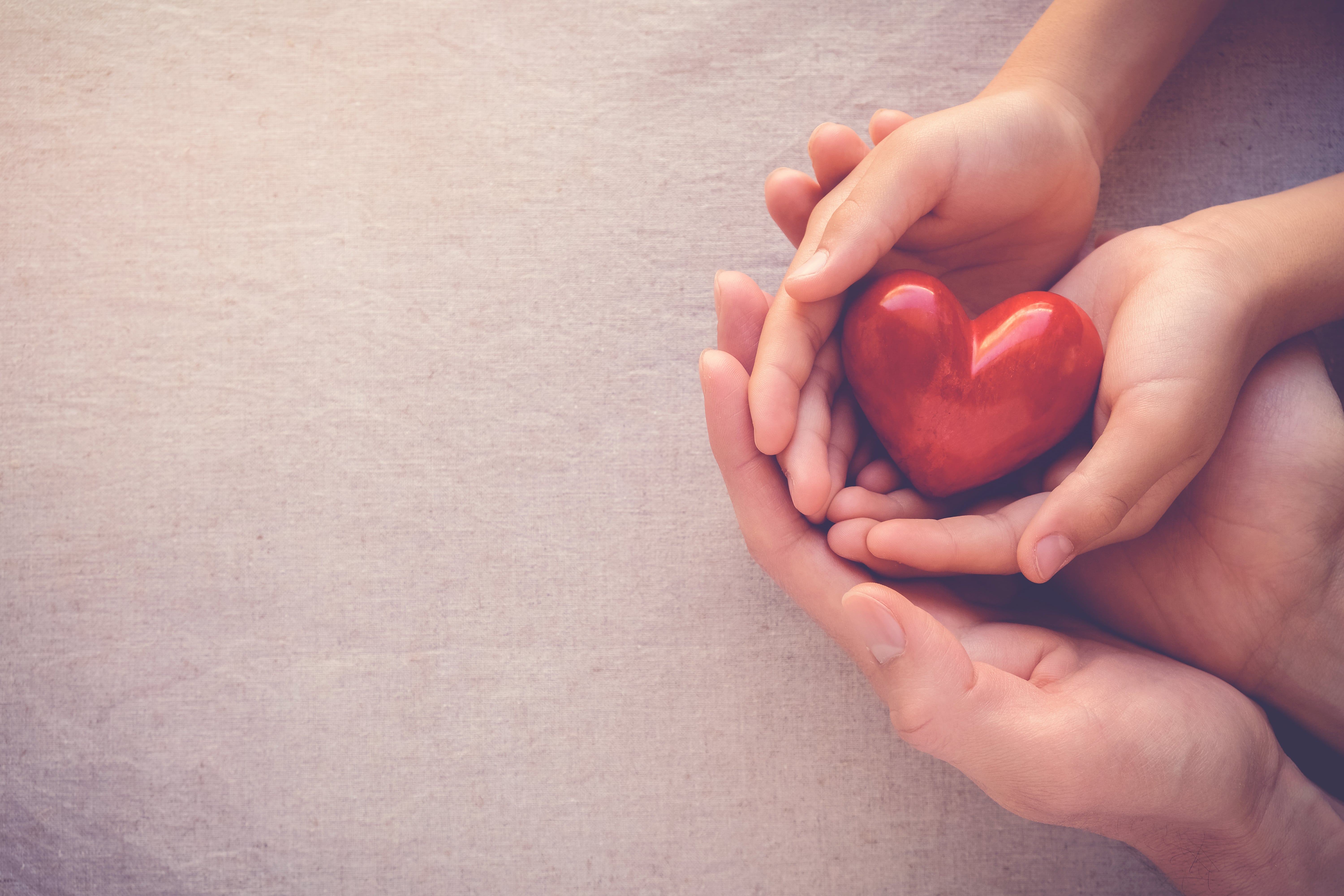 hands holding a ceramic heart